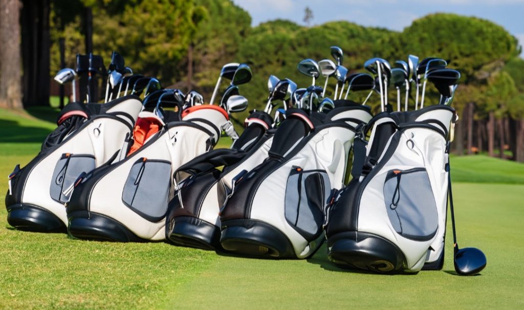 Budget golf bags lined up on a golf course