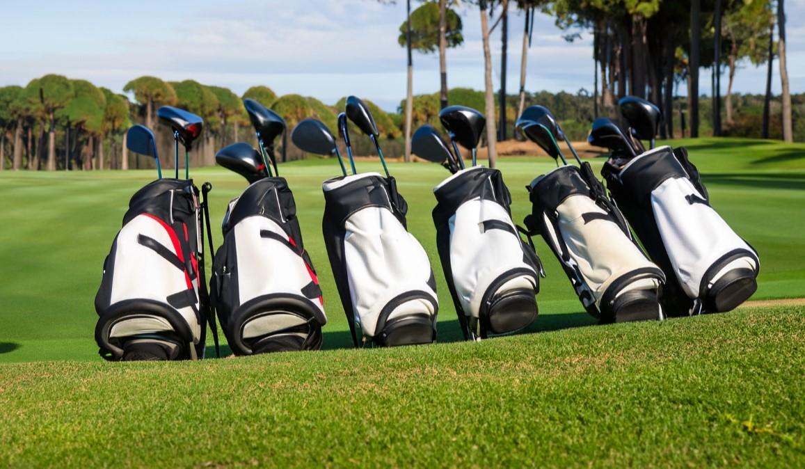 Golf bags lined up on a golf course