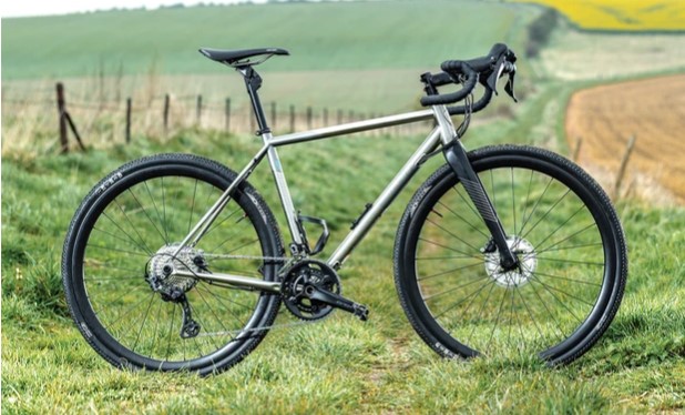titanium gravel bike on a dirt trail